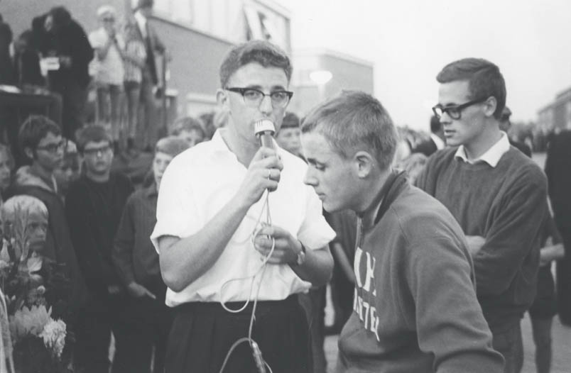 De koers gaat Hennie Kuiper beter af dan de ontmoetingen met de microfonist, zoals hier in 1966 als eerstejaars nieuweling in de Ronde van Zwartsluis