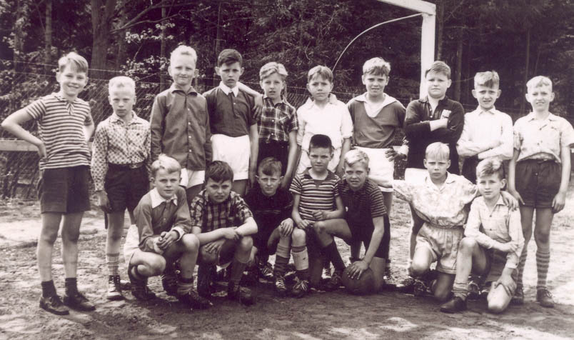 Just like any healthy Dutch boy, Hennie also enjoys playing football. Here he is kneeling all the way to the left in the front row of his street football team.