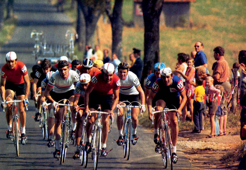 At 80 kilometers into the race, a breakaway forms in the Olympic road race with Swiss rider Ueli Sutter (321) on the far left and his compatriot Ivan Schmid (319) at the front. To the left of Schmid is Cees Priem (198), and to the right of Schmid is Hennie Kuiper (194). Riding between Priem and Schmid is later third-place finisher Jaime Huélamo (102). On the right: Freddy Maertens (35) and British rider Phil Bayton (141). Fedor den Hertog has not yet bridged the gap to this group, but will later catch up and play an important role in the finale.