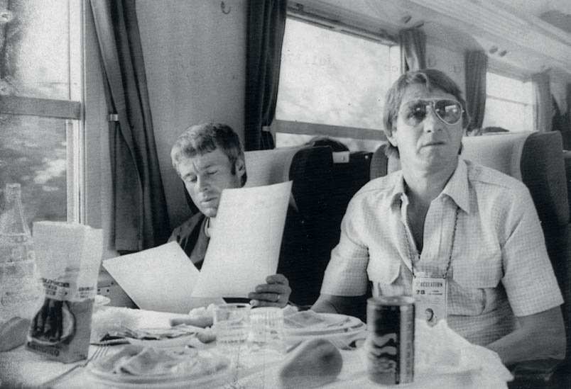 Before the start of the thirteenth stage of the 1978 Tour, the peloton travels by train from Toulouse to Figeac. Peter Post and Hennie Kuiper have breakfast together, but Kuiper also studies the route schedule for the day with concentration.