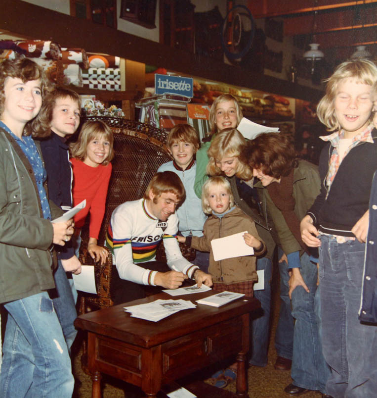 In a furniture store in Winterswijk, Hennie Kuiper happily signs autograph cards for the local youth